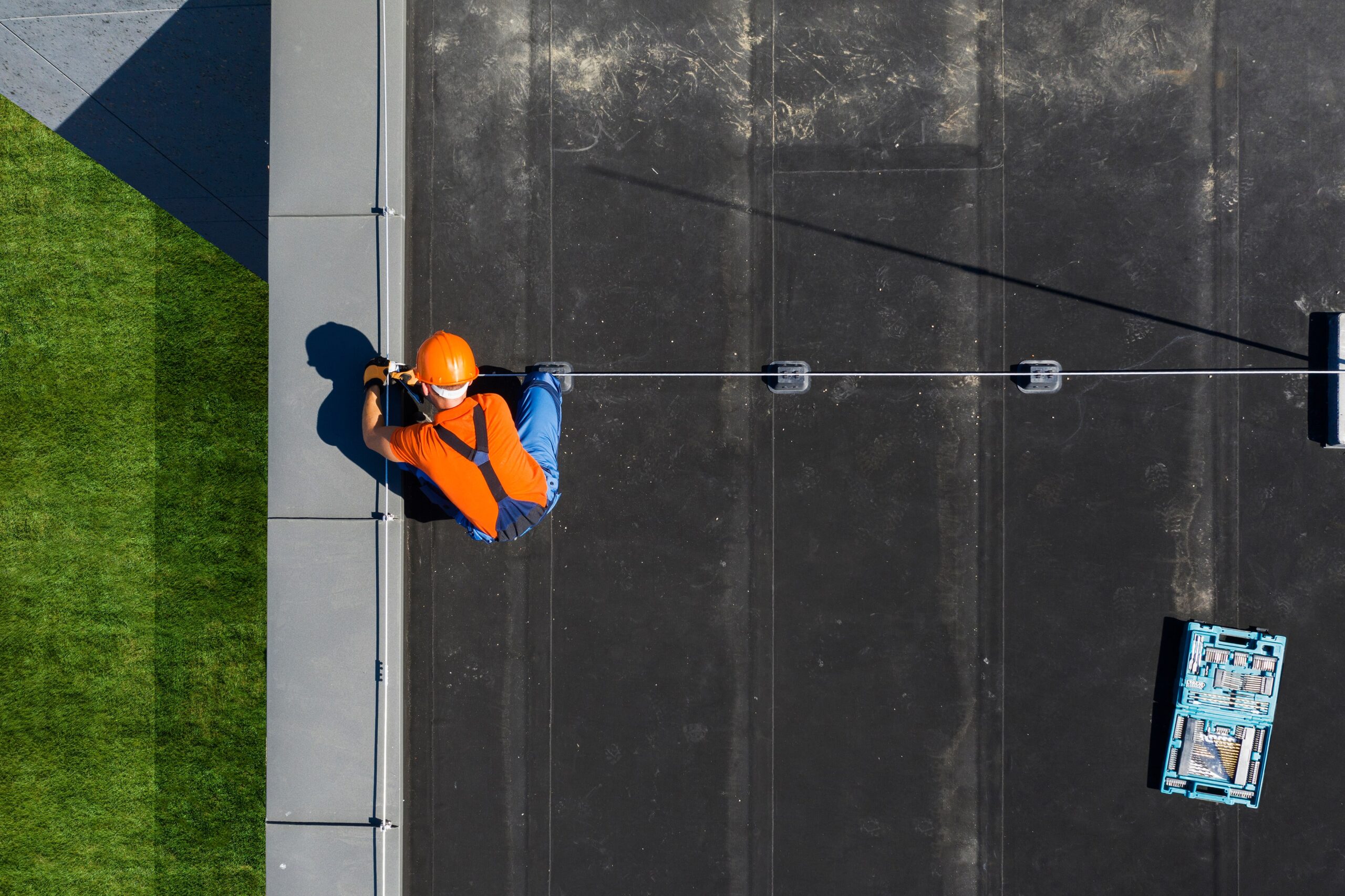 top down picture of roofer working on commercial roof 